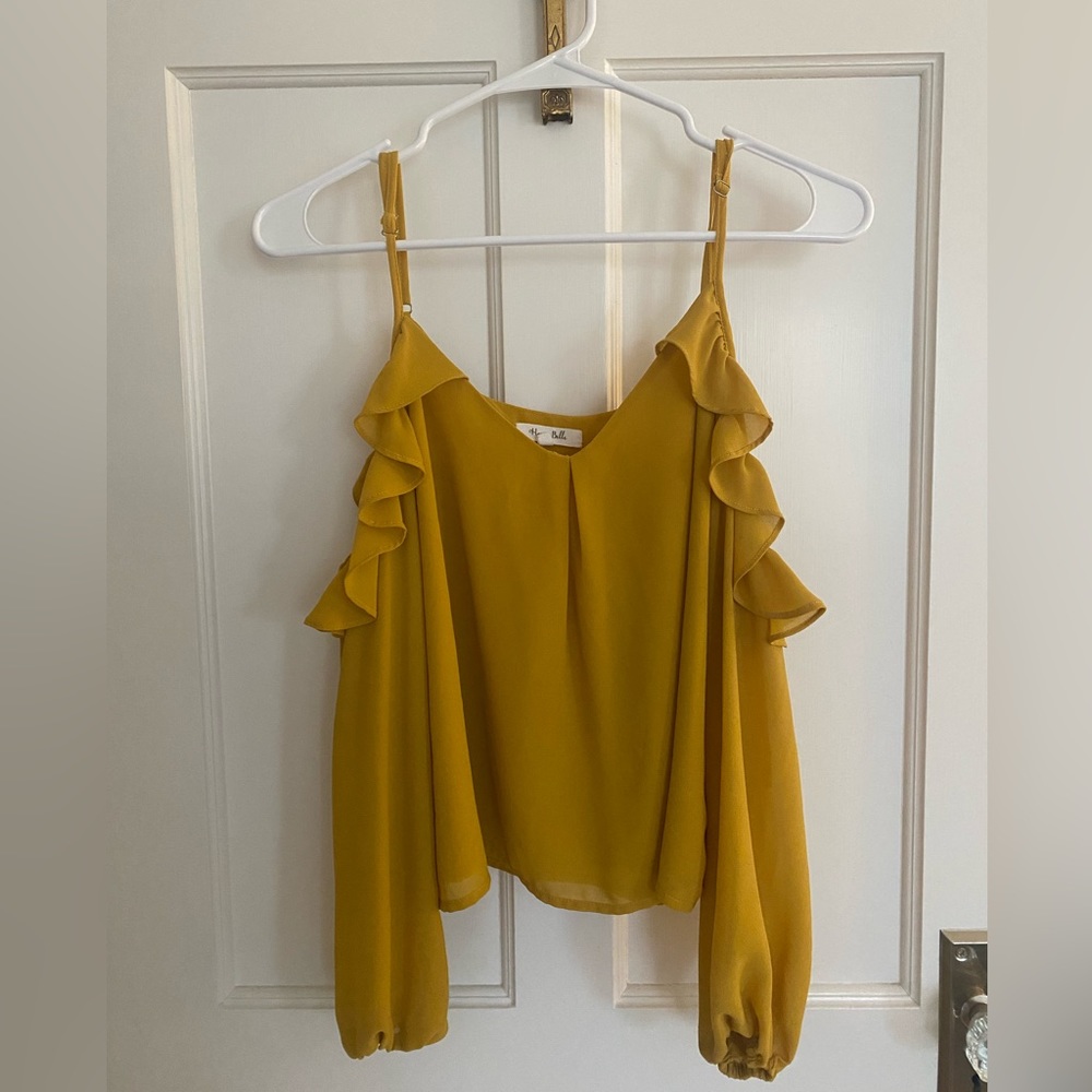 Mustard blouse with shoulder cut-outs and flutter sleeve.